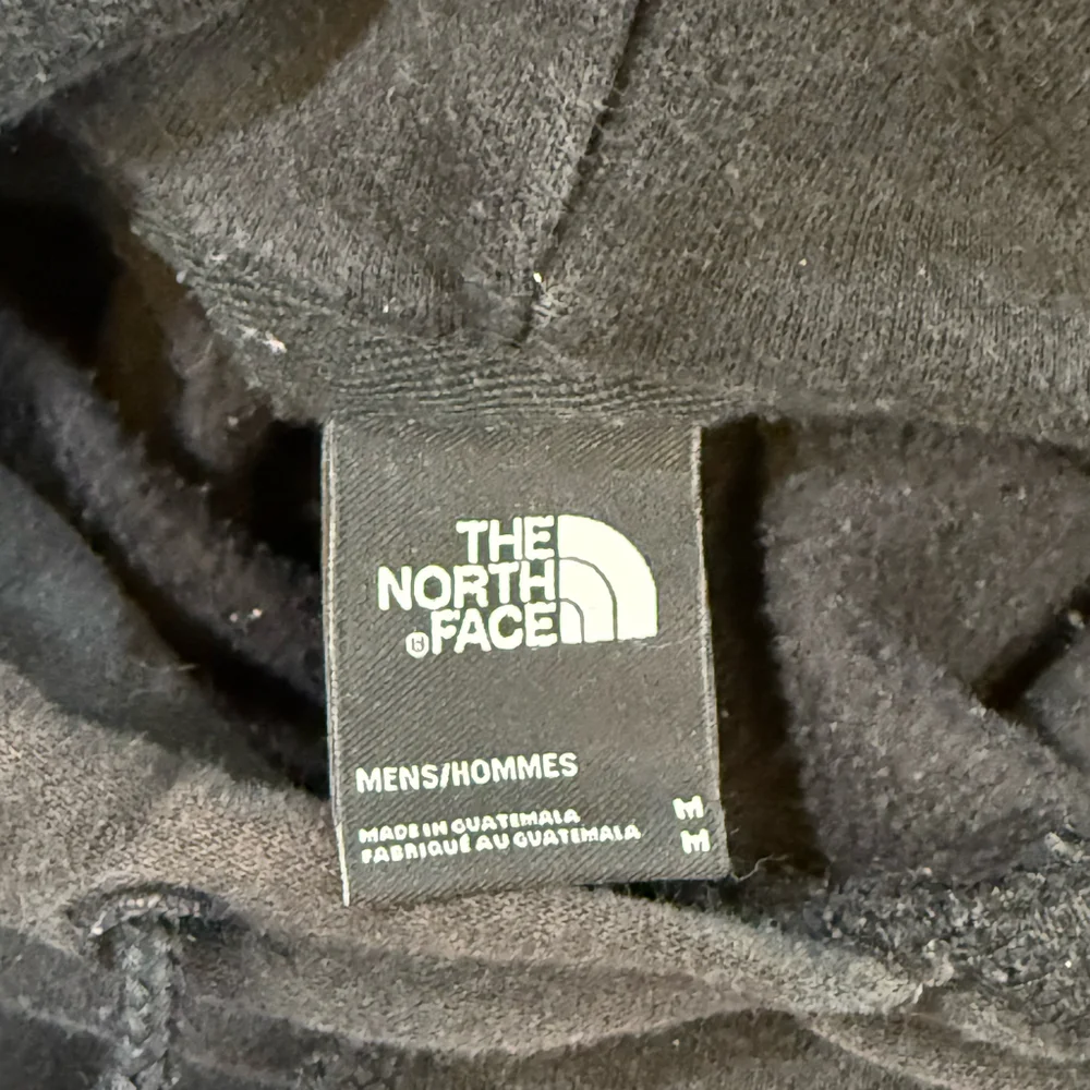 The North Face Black Hoodie with Red Logo Patch